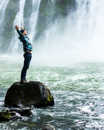 Man Standing On Black Rock